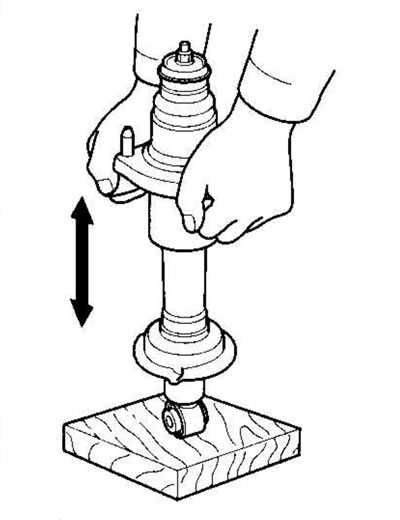 4. Press the shock absorber assembly with your…